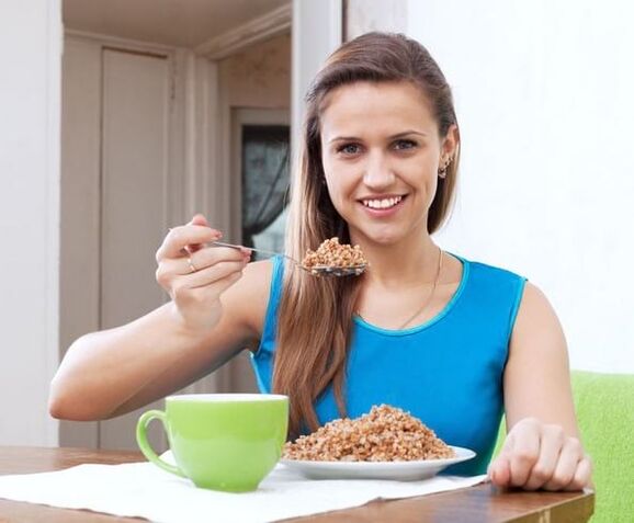 Girl eats buckwheat for weight loss